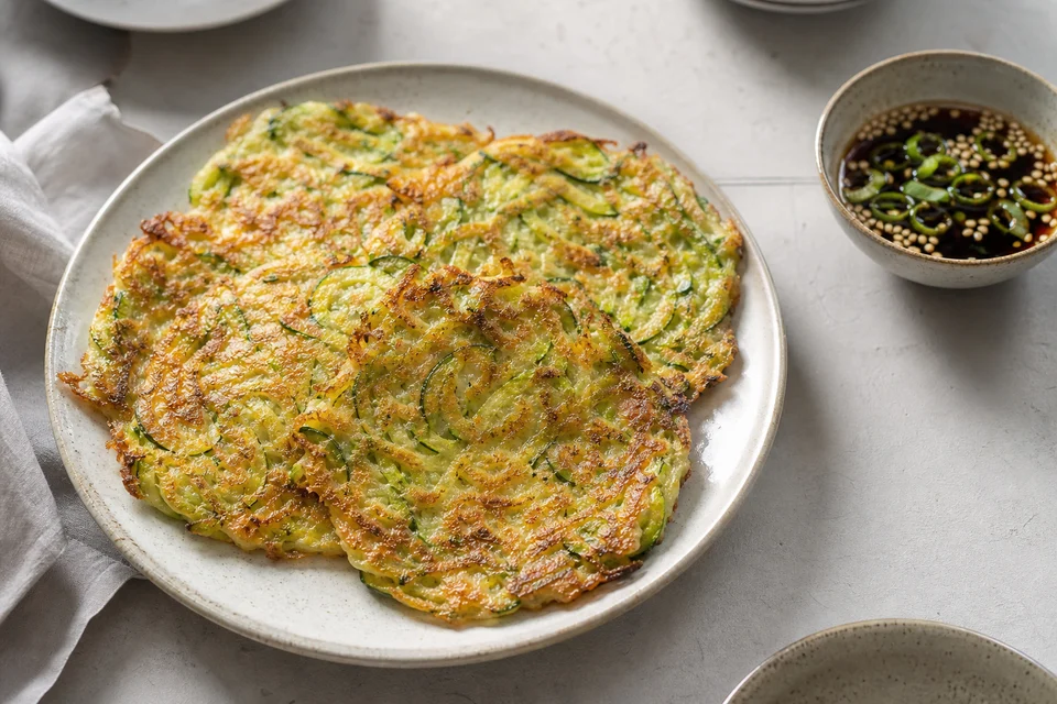 Crisp grated Korean courgette pancakes with soy-vinegar sesame dipping sauce.