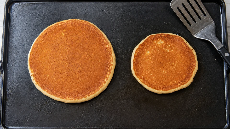 Editorial setup illustrating why pancakes shrink after flipping.