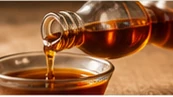 Maple syrup pouring into a dish