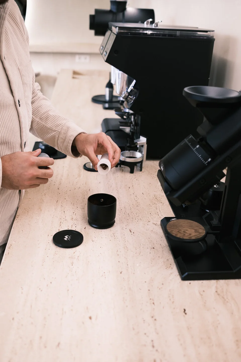 Coffee beans being measured beside the grinders at Kanso Coffee Lab