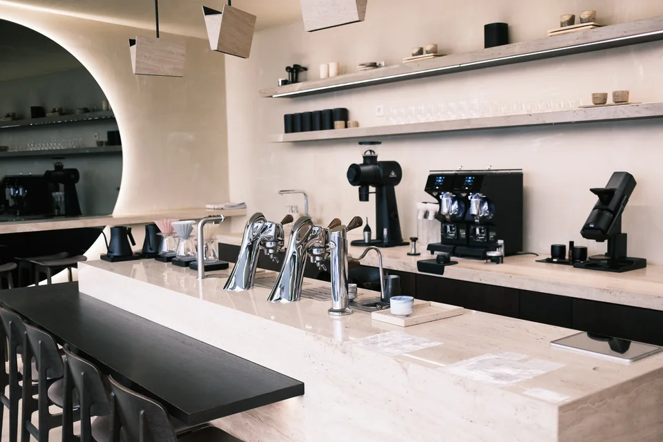 Kanso Coffee Lab's pale stone coffee bar and espresso equipment in Munich
