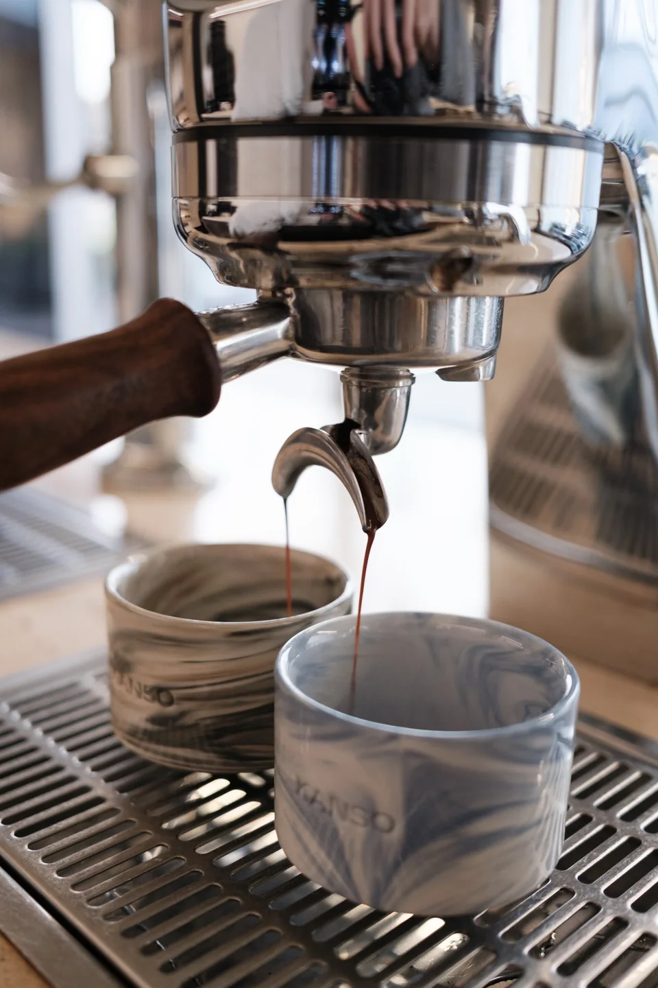Espresso flowing into two handmade cups at Kanso Coffee Lab