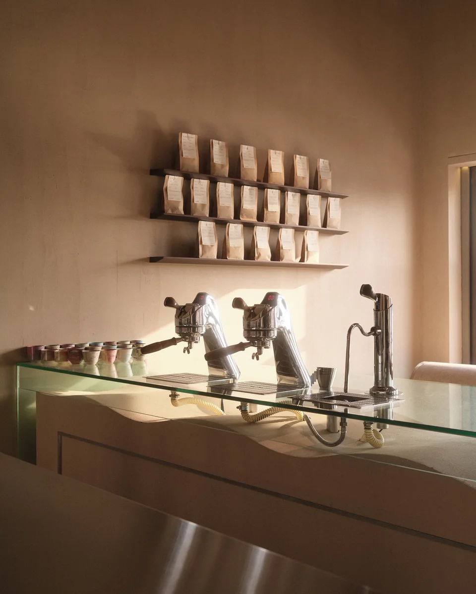 Sunlight across the espresso bar and coffee display inside Kanso Coffee Lab